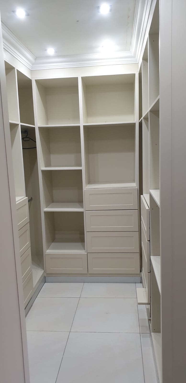 Walk-in closet with shelves and drawers